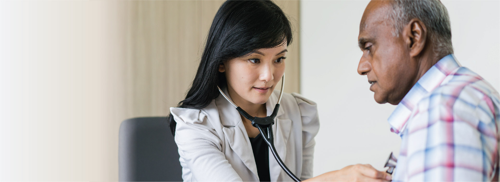 Family physician providing health examination to an elderly man at NUHS Family Medicine Clinic.