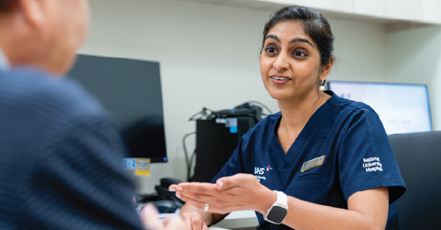 Photo of an NUHS doctor talking to a patient