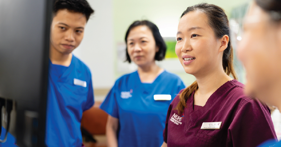 NUHS healthcare workers looking at a report