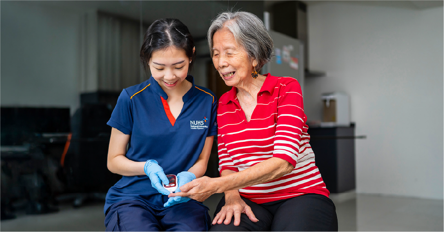 A nurse assisting an elderly woman with blood glucose monitoring