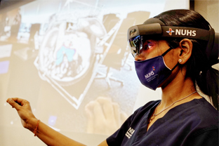 NUH neurosurgeon wears a holographic visor to look at a three-dimensional (3D) hologram of a patient’s brain scan 
